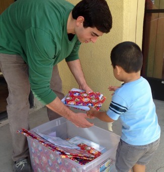 Michael Camarda distributing gift-wrapped books in Fountain Valley