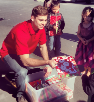 Nick Camarda distributing gift-wrapped books