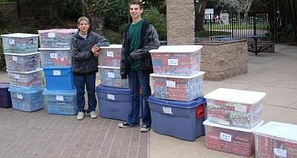 Michael and Nick Camarda ready to distribute donated gift-wrapped books