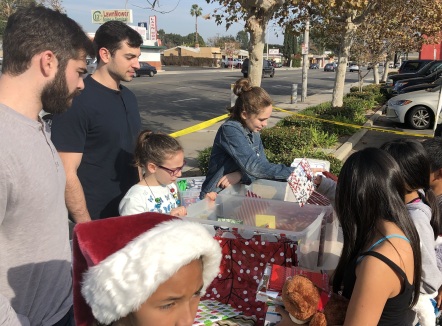 Nick and Michael Camarda distributing gift-wrapped books