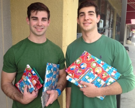 Nick and Michael Camarda distributing gift-wrapped books