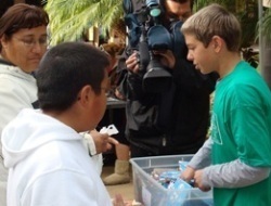 Michael Camarda distributes donated gift-wrapped books