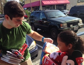 Nick Camarda distributing donated gift-wrapped books in 2014